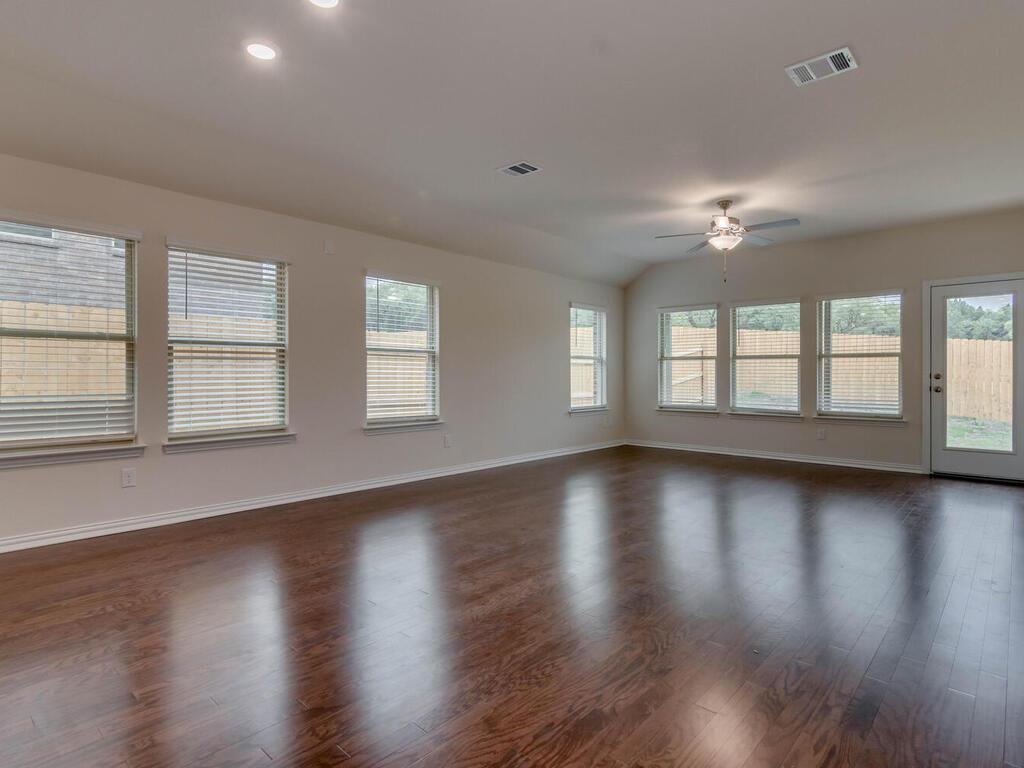 1104 Ridge Runner Drive Georgetown, TX 78628 - Photo 7 of 27 a view of an empty room with wooden floor and a window
