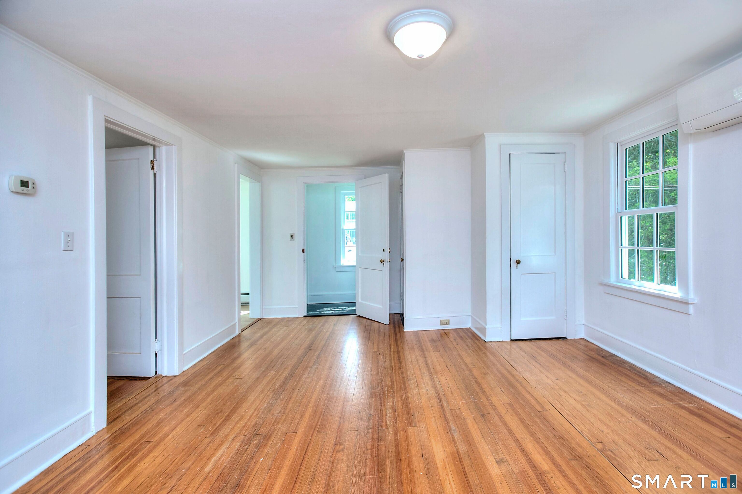 94 Honey Hill Road Wilton, CT 06897 - Photo 5 of 18 a view of a room with wooden floor and window
