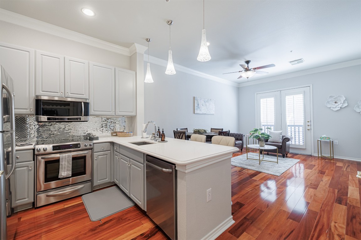 2400 McCue Road, Unit 112 Houston, TX 77056 - Photo 1 of 24 a kitchen with a sink stove and microwave