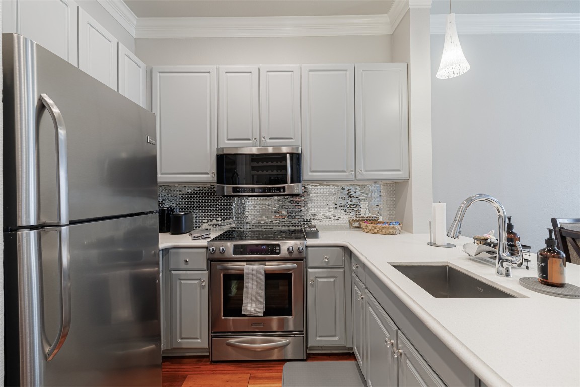 2400 McCue Road, Unit 112 Houston, TX 77056 - Photo 2 of 24 a kitchen with a refrigerator sink and white cabinets