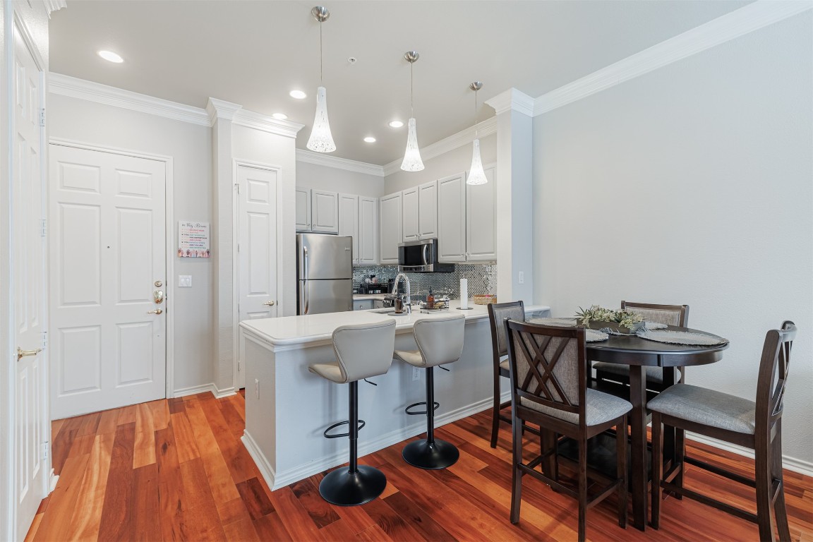 2400 McCue Road, Unit 112 Houston, TX 77056 - Photo 3 of 24 a view of a dining room with furniture and wooden floor