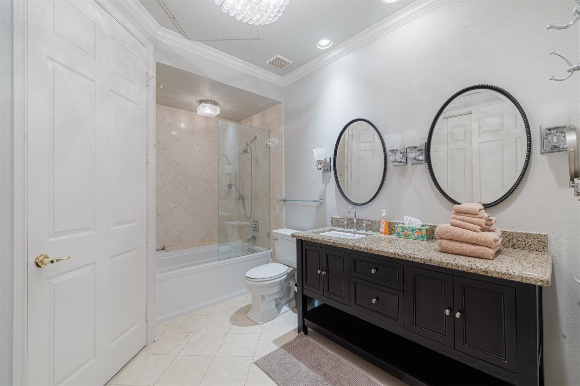 2400 McCue Road, Unit 112 Houston, TX 77056 - Photo 9 of 24 a bathroom with a toilet a double vanity sink and a mirror