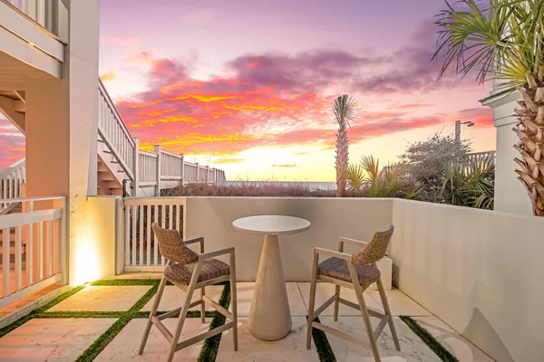 a view of a balcony with furniture and a floor to ceiling window