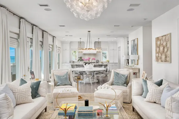 a living room with furniture and a chandelier