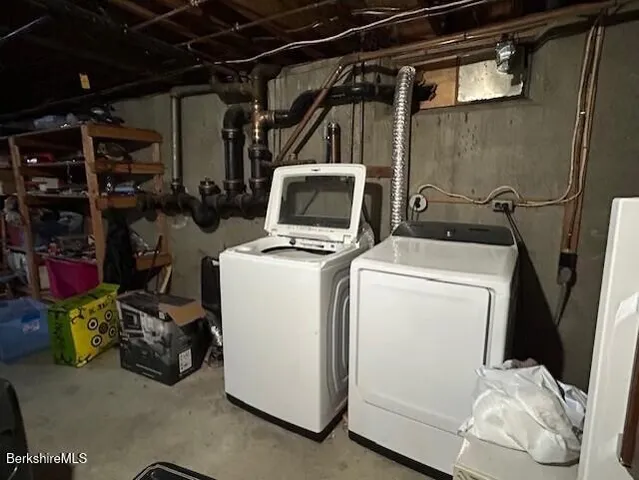a view of storage and utility room with washer and dryer