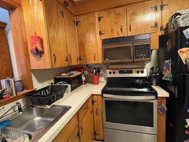 a kitchen with a stove and a sink