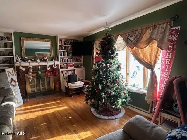a living room with furniture a flat screen tv and a fireplace