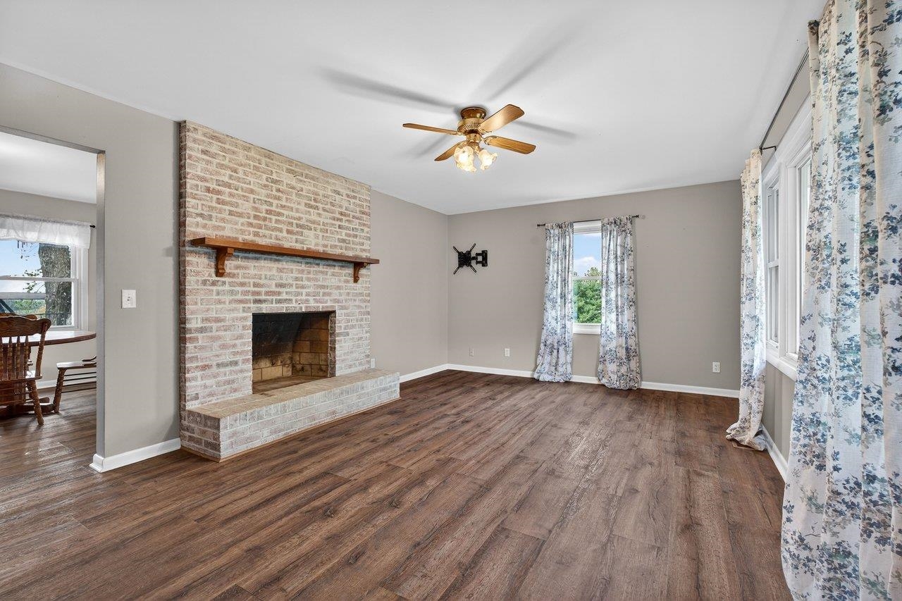 3259 Zion Church Road Broadway, VA 22815 - Photo 2 of 48 a view of an empty room with a fireplace and a window