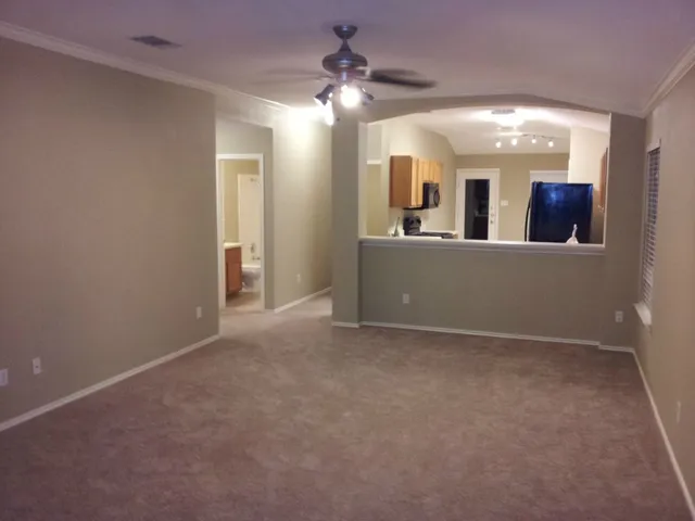 a view of a hallway with chandelier