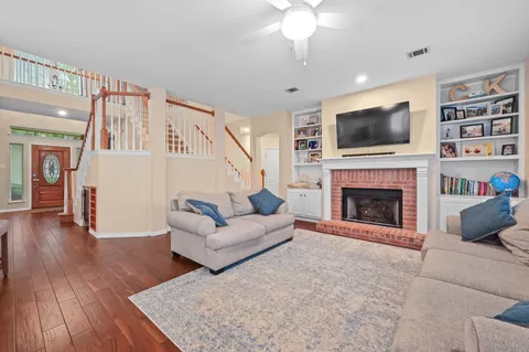 a living room with furniture fireplace and flat screen tv