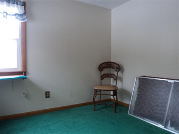259 Mallowhill Road Springfield, MA 01129 - Photo 8 of 11 a room with a chair and a potted plant next to a window