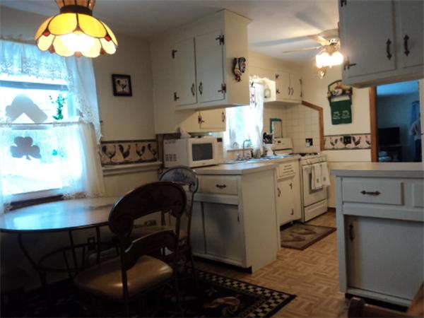 259 Mallowhill Road Springfield, MA 01129 - Photo 10 of 11 a kitchen with stainless steel appliances a stove a sink cabinets and a dining table