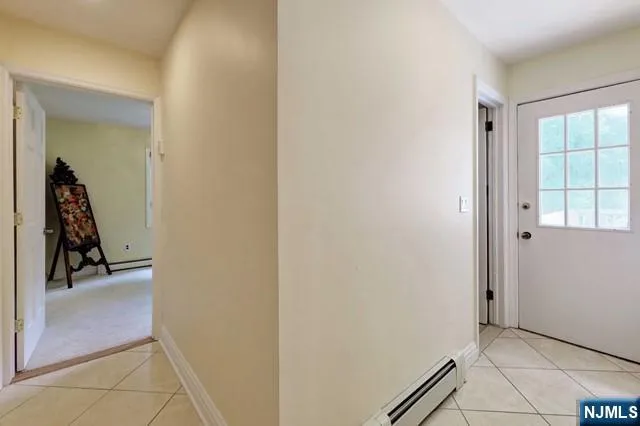 a view of room with hallway and closet