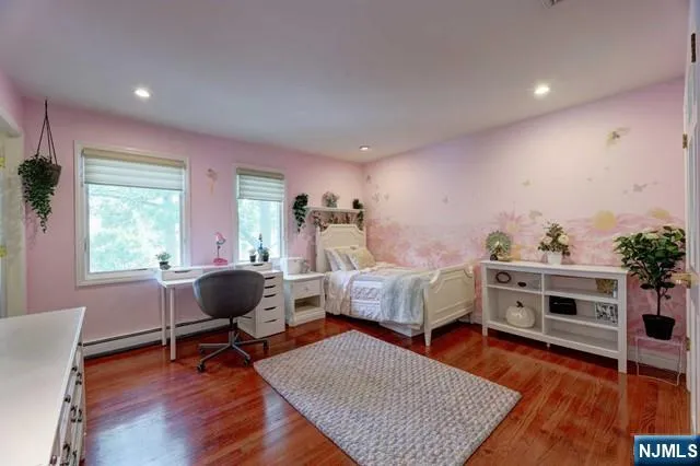 a bedroom with furniture and a wooden floor