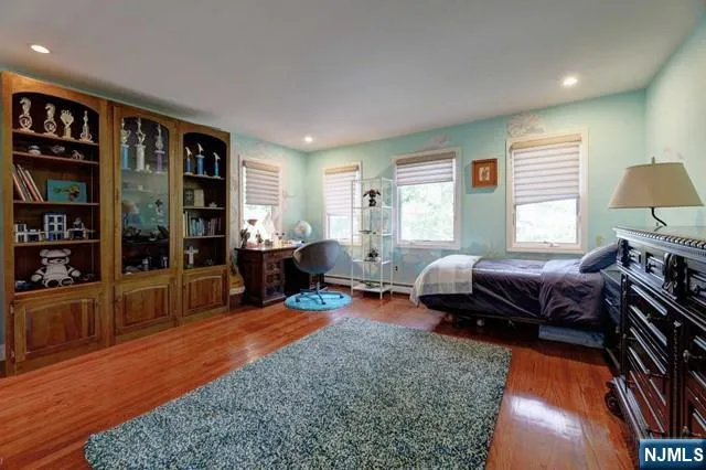 a bedroom with furniture and a book shelf