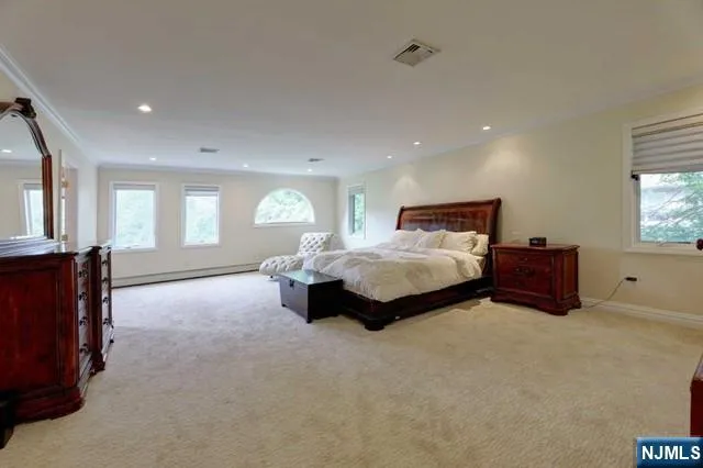a spacious bedroom with a bed and window
