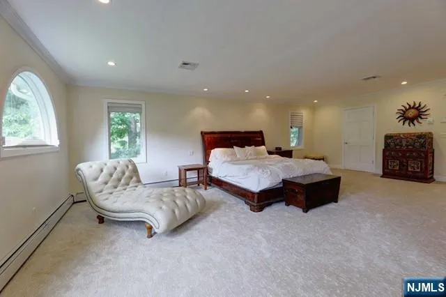 a spacious bedroom with a bed and a couch