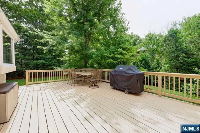 a view of deck with table a barbeque grill with wooden floor and fence