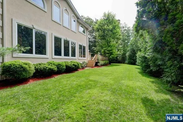 a view of a house with backyard sitting area and garden