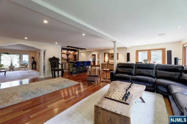 a living room with furniture and a wooden floor