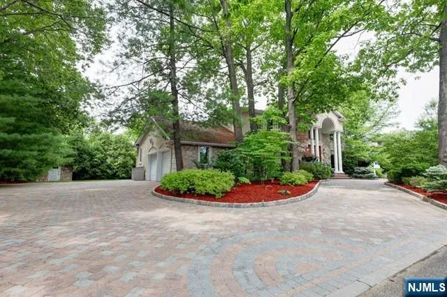 a front view of a house with a yard and plants