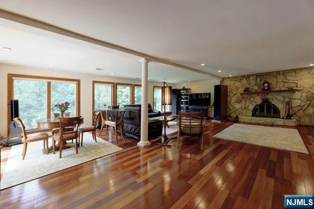 a living room with furniture and a wooden floor