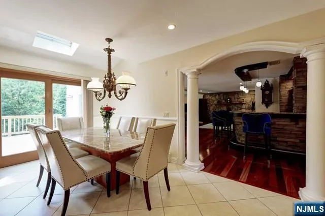 a dining room with furniture window and wooden floor
