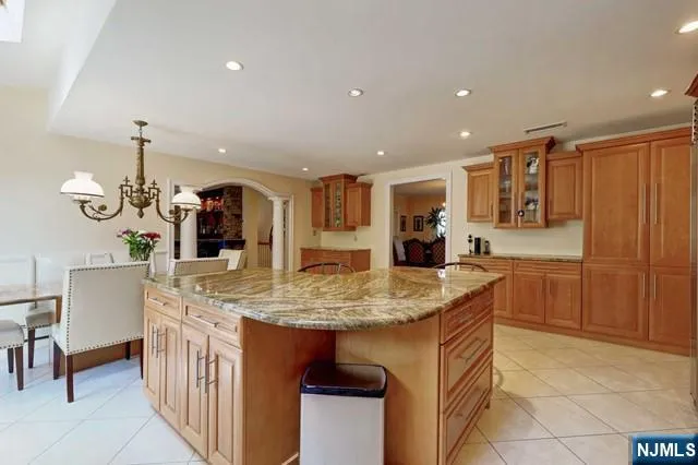 a kitchen with stainless steel appliances granite countertop a sink and a refrigerator