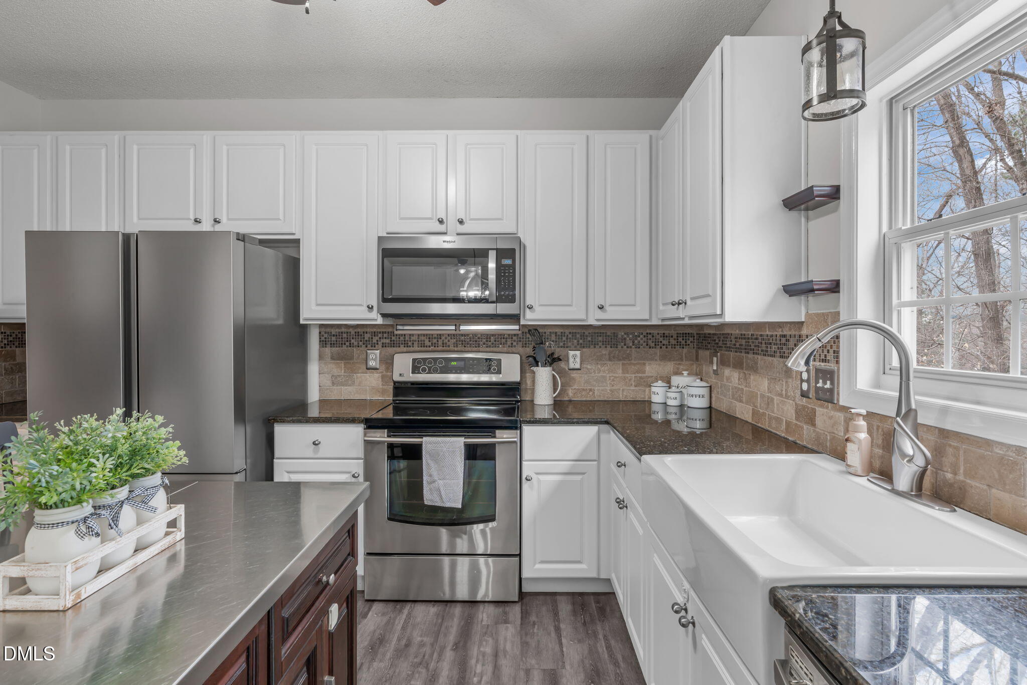 2501 Springfield Park Drive Raleigh, NC 27614 - Photo 14 of 44 a kitchen with stainless steel appliances a stove a sink a refrigerator a stove a microwave and cabinets