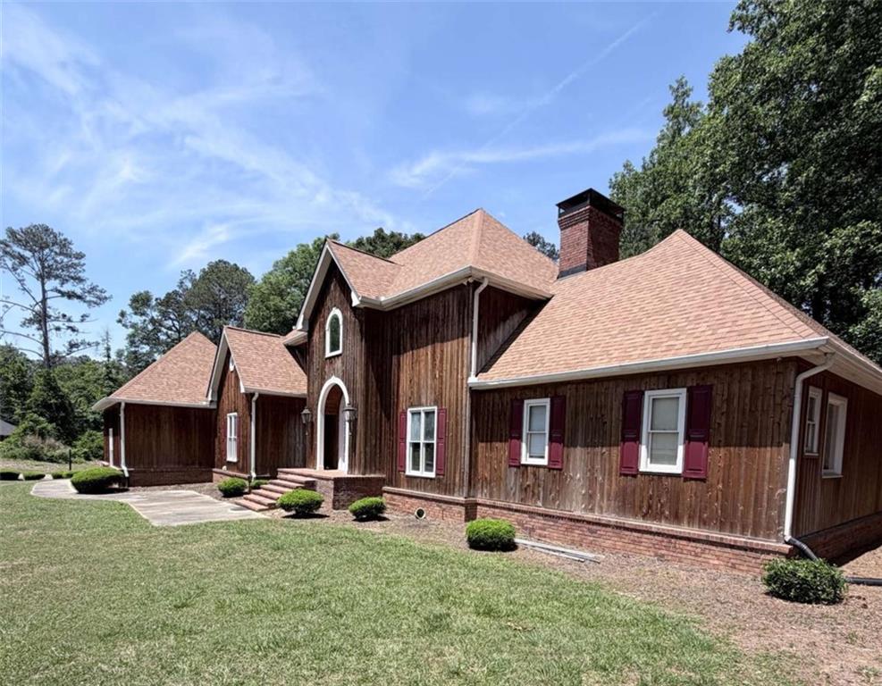 763 McDaniel Mill Road Southwest Conyers, GA 30094 - Photo 2 of 80 a front view of a house with yard porch and furniture