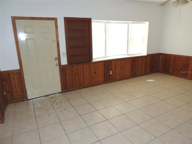 a view of an empty room with wooden door