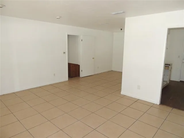 an empty room with windows and closet