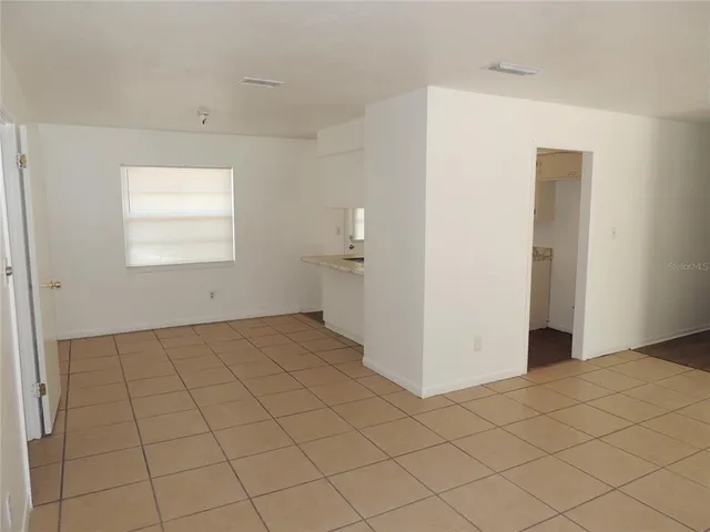 a kitchen with granite countertop white cabinets and sink