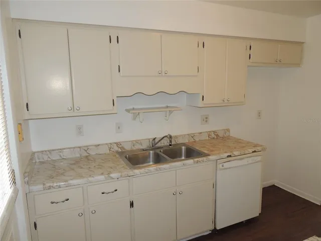 a kitchen with a refrigerator stove and sink