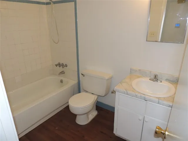 an empty room with a window and a ceiling fan