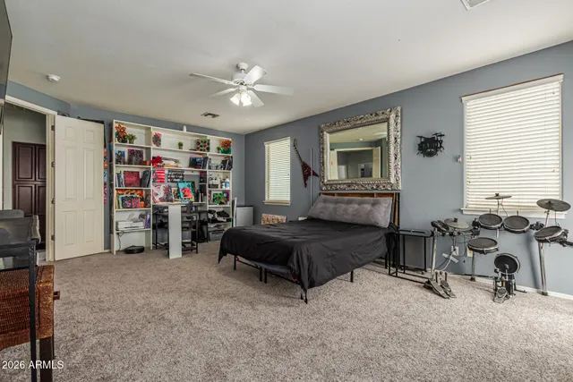 a bedroom with furniture and a large window