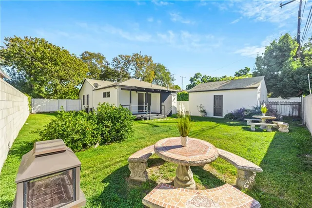 a view of a house with backyard sitting area and garden