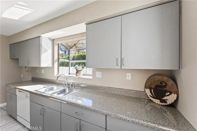 a kitchen with a sink and cabinets