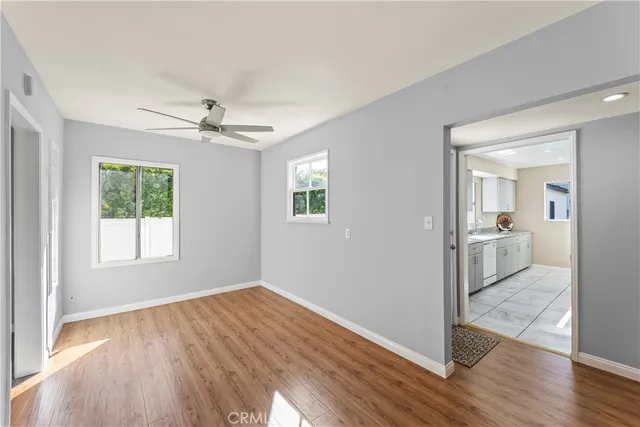 a view of a room with wooden floor and a bathroom