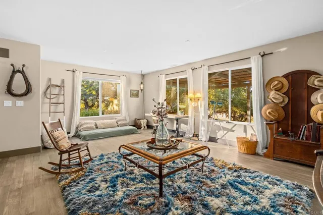 a view of a dining room with furniture a kitchen and chandelier
