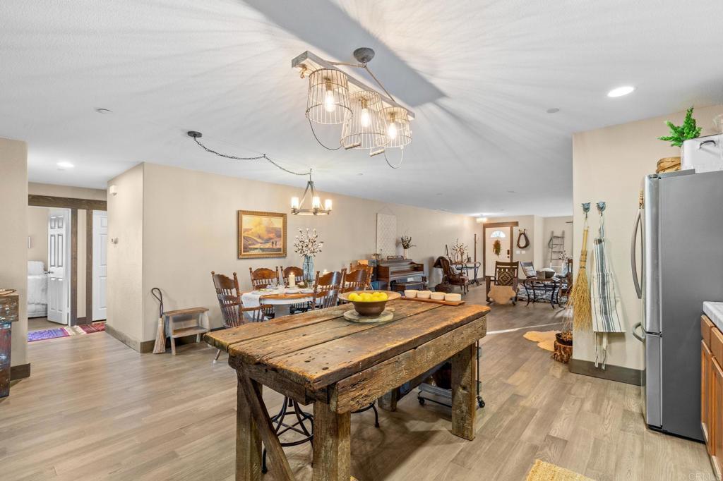 25258 Black Canyon Road Santa Ysabel, CA 92070 - Photo 29 of 71 a view of a dining room with furniture a kitchen and chandelier