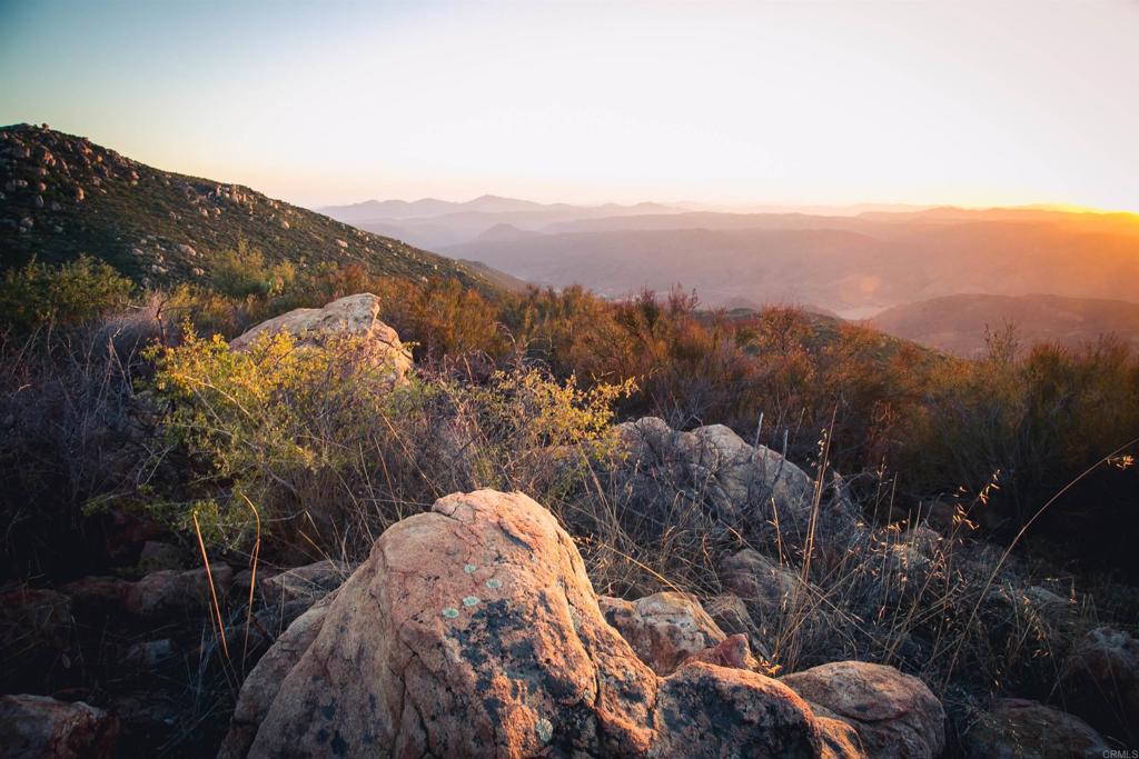 25258 Black Canyon Road Santa Ysabel, CA 92070 - Photo 62 of 69 a view of a house with a mountain in the background