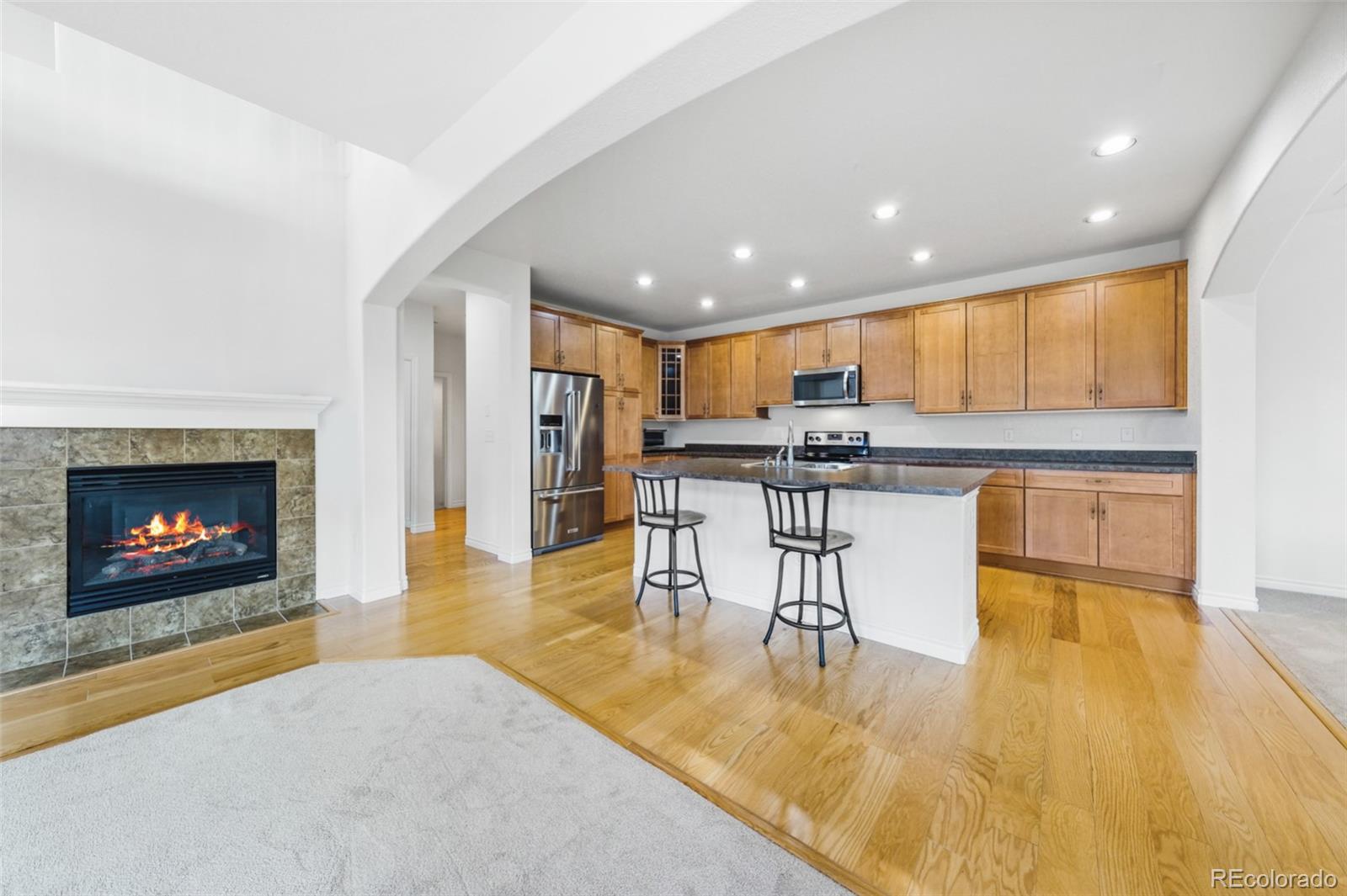 9550 Rosato Court Highlands Ranch, CO 80126 - Photo 11 of 27 a kitchen with a table chairs refrigerator and cabinets