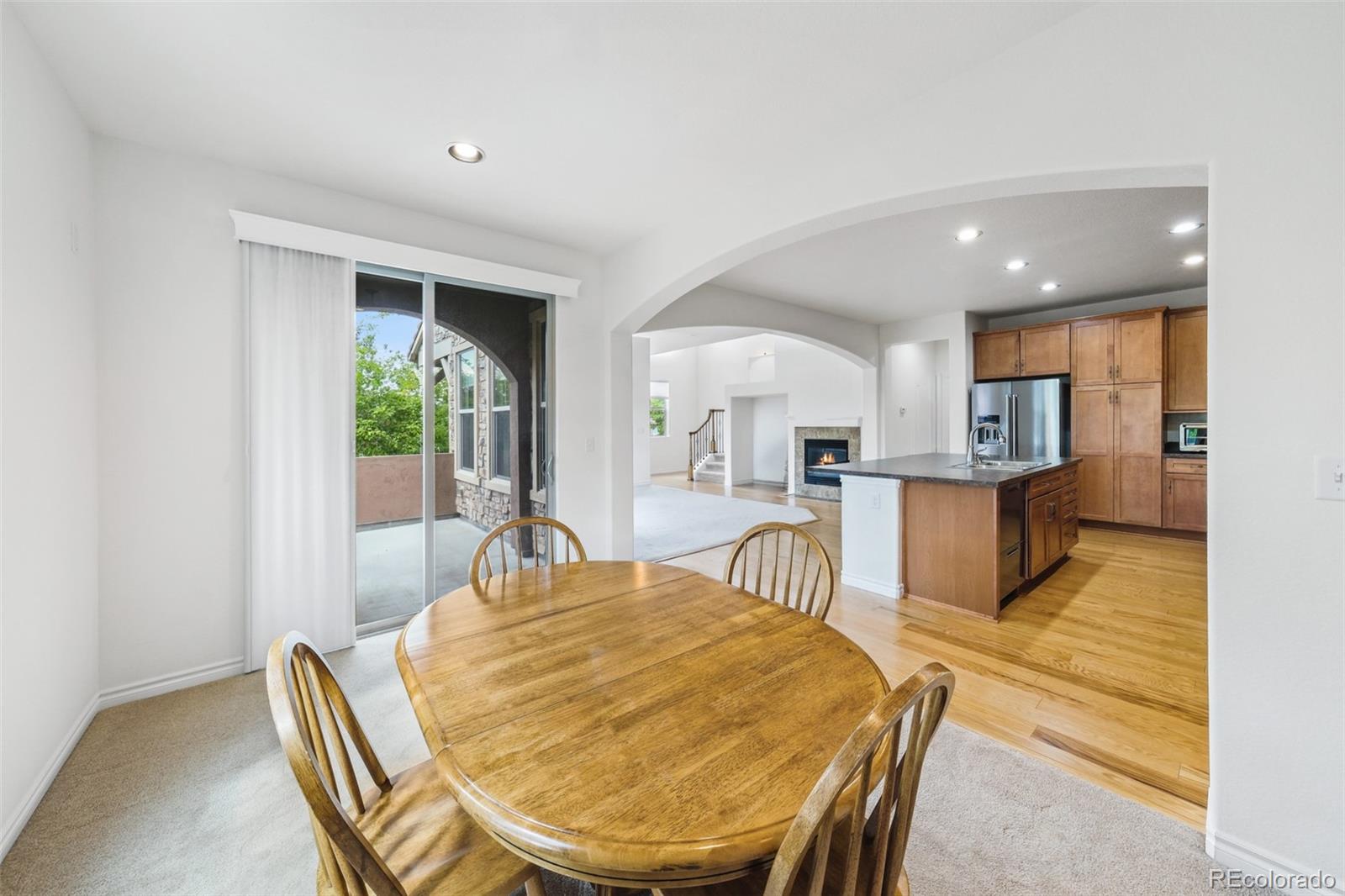 9550 Rosato Court Highlands Ranch, CO 80126 - Photo 12 of 27 a living room with furniture a wooden floor and kitchen view