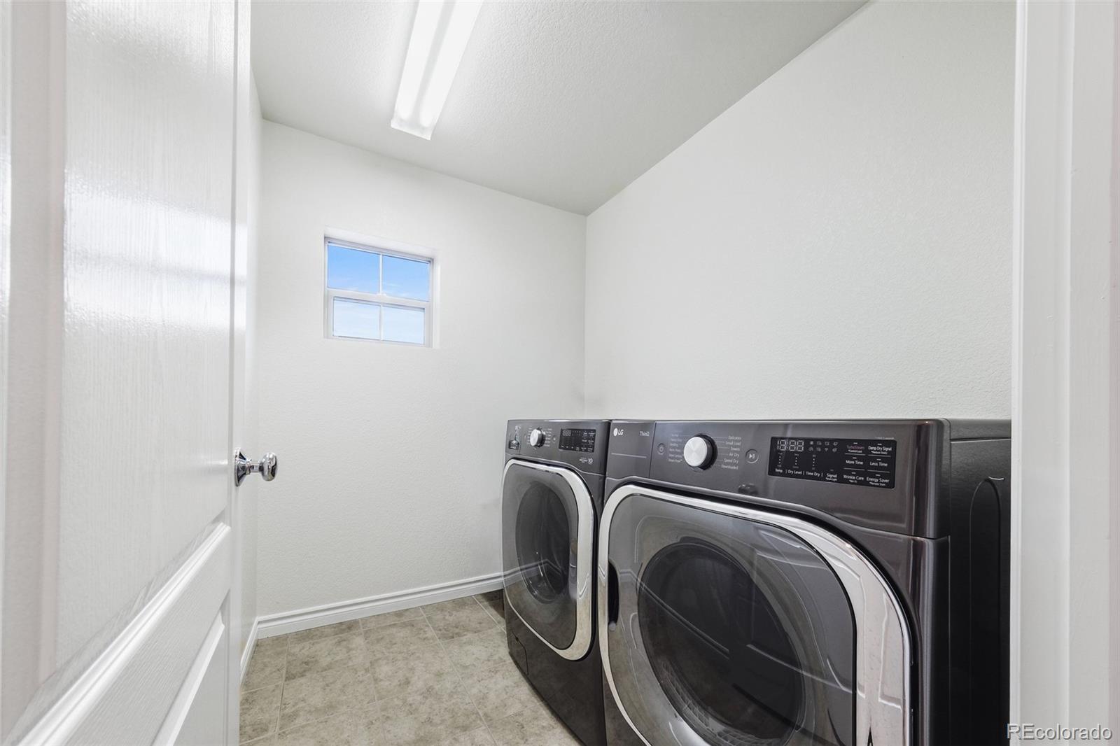 9550 Rosato Court Highlands Ranch, CO 80126 - Photo 19 of 27 a utility room with dryer and washer