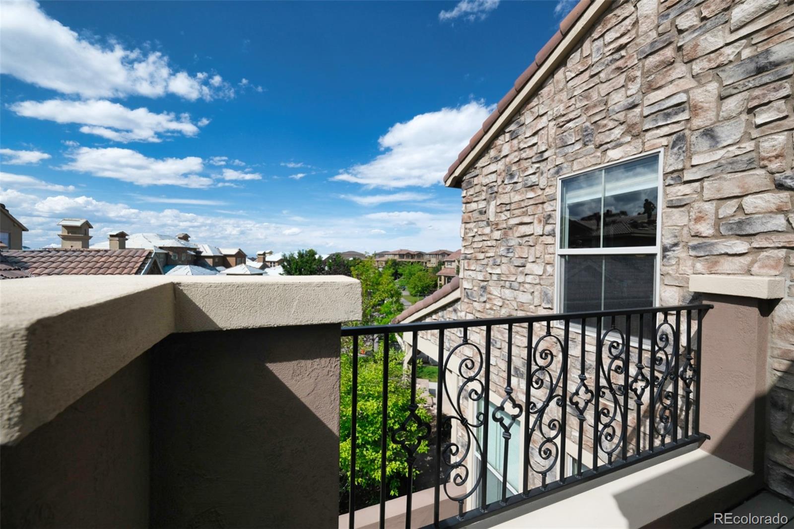 9550 Rosato Court Highlands Ranch, CO 80126 - Photo 23 of 27 a view of a balcony with wooden floor and fence
