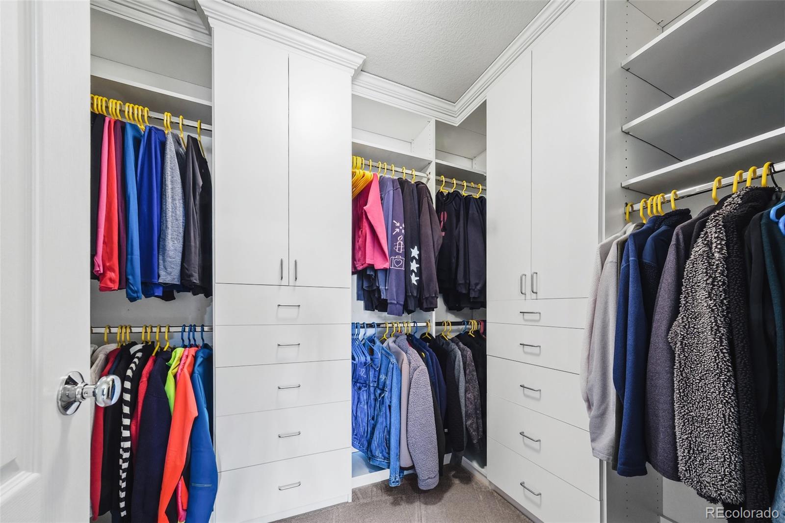 9550 Rosato Court Highlands Ranch, CO 80126 - Photo 26 of 27 a view of walk in closet with clothes