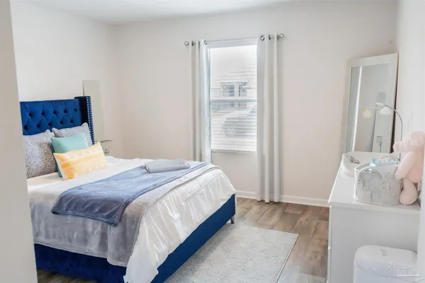 a bedroom with a bed and window