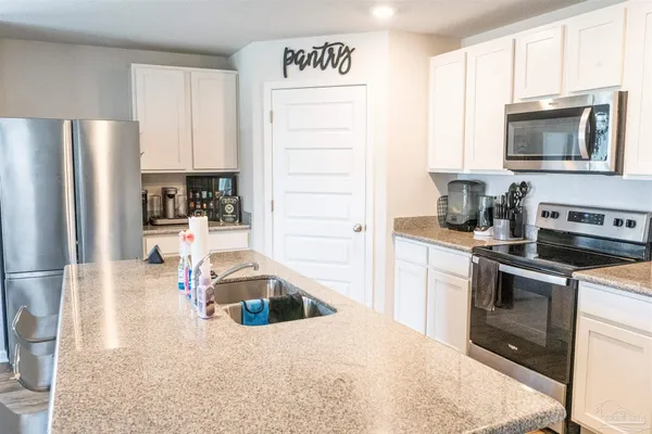 a kitchen with a sink stainless steel appliances and cabinets
