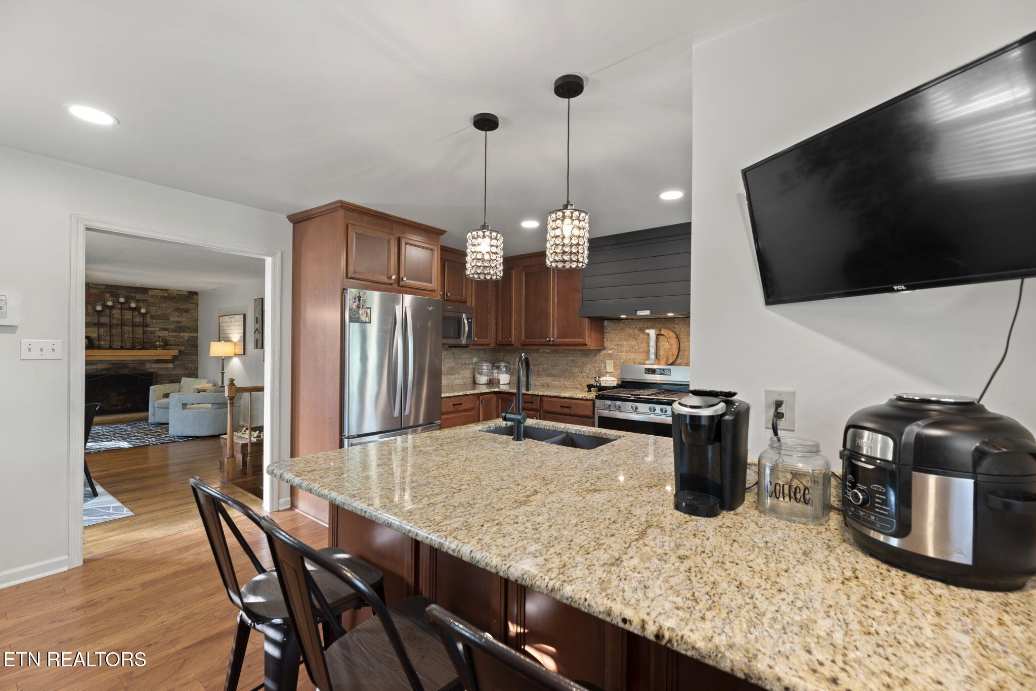 83 Outer Drive Oak Ridge, TN 37830 - Photo 18 of 37 a kitchen with stainless steel appliances granite countertop a sink a stove and a wooden floors